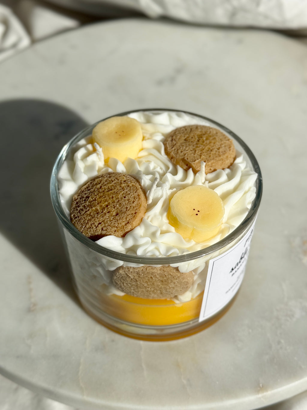 Top view of hand-poured Banana Shortbread scented candle by Petit Bisou, dessert-inspired and handmade in New York