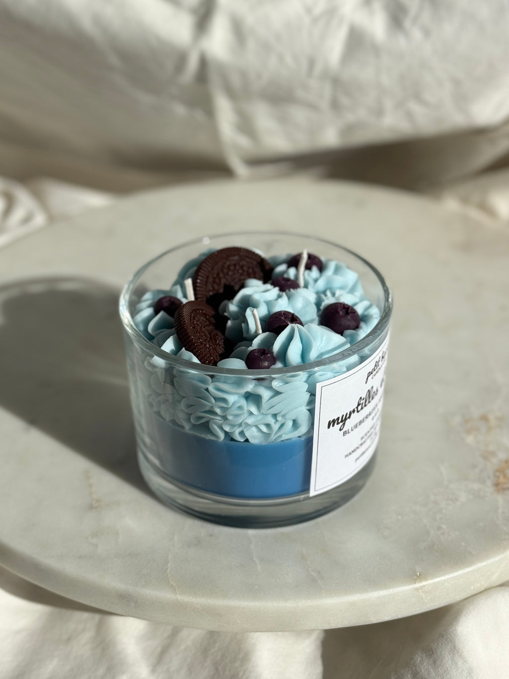 Side view of hand-poured blueberry cream oreo scented candle by Petit Bisou, dessert-inspired and handmade in New York