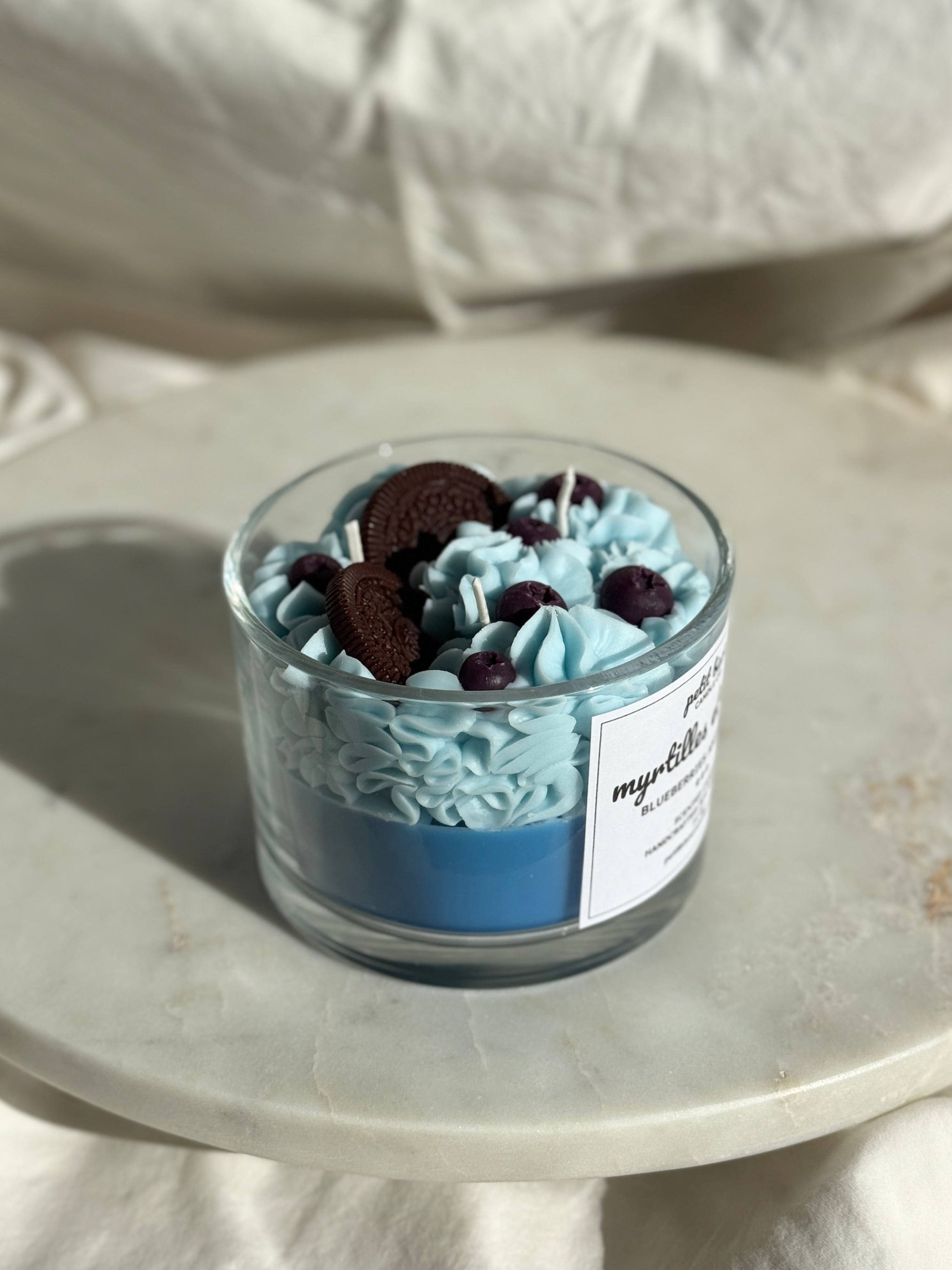 Side view of hand-poured blueberry cream oreo scented candle by Petit Bisou, dessert-inspired and handmade in New York