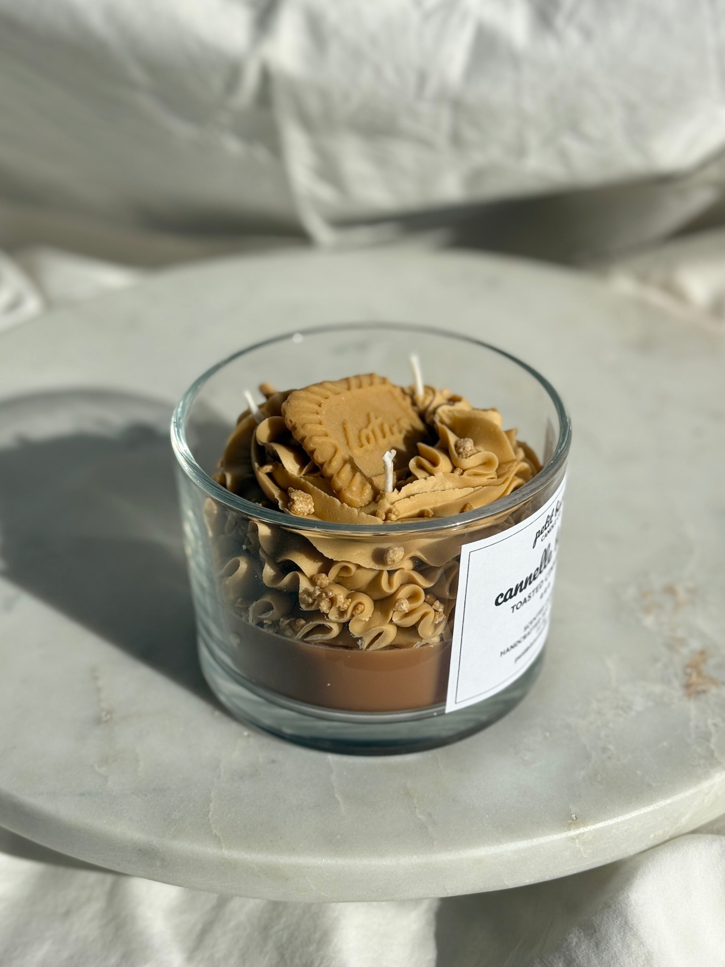 Side view of hand-poured cinnamon toastscented candle by Petit Bisou, dessert-inspired and handmade in New York