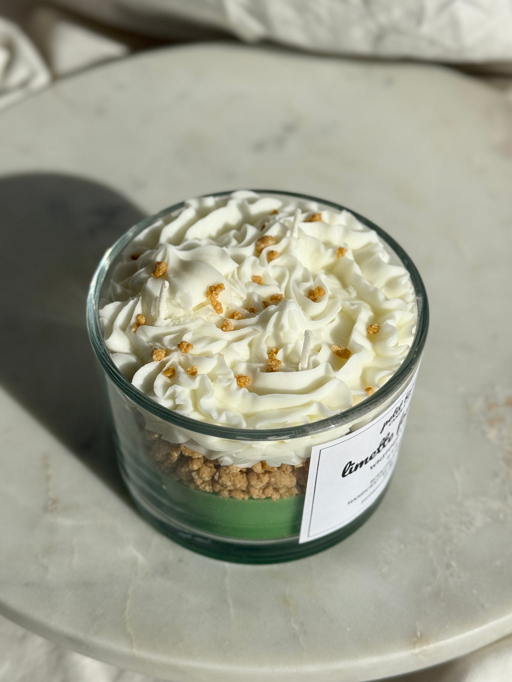 Top view of hand-poured key lime pie scented candle by Petit Bisou, dessert-inspired and handmade in New York