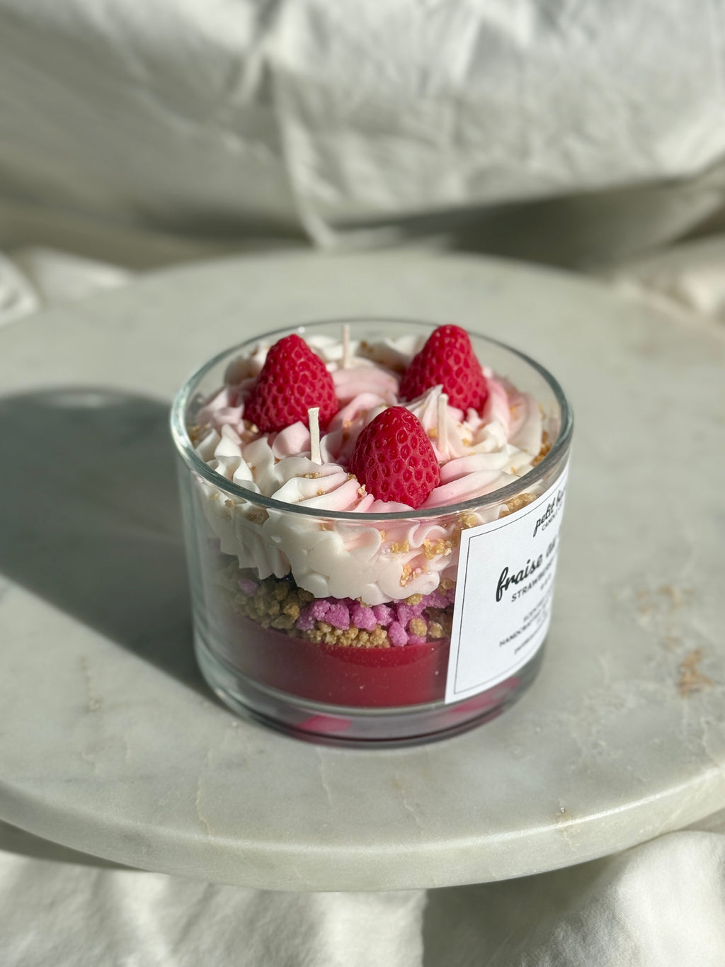 Side view of hand-poured Strawberry shortcake scented candle by Petit Bisou, dessert-inspired and handmade in New York
