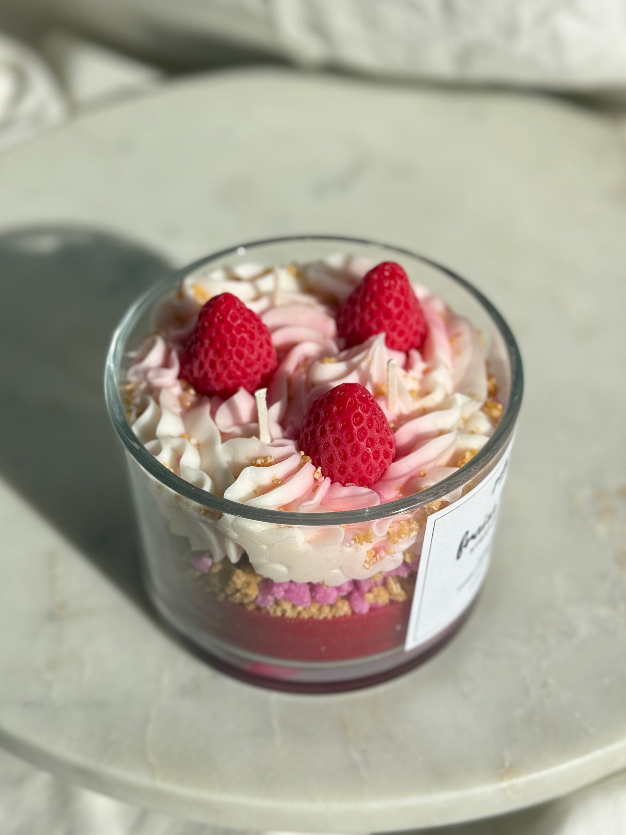 Top view of hand-poured Strawberry shortcake scented candle by Petit Bisou, dessert-inspired and handmade in New York